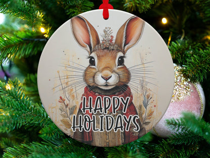 Festive bunny ornament featuring expressive rabbit artwork, botanical accents, and woodland holiday styling.