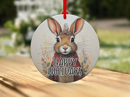 Christmas tree ornament with watercolour bunny illustration, floral headpiece, and Happy Holidays message.