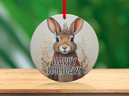 Woodland rabbit holiday ornament featuring rustic red clothing, delicate whiskers, and nature-inspired artwork.