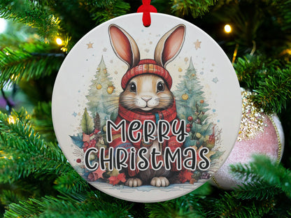 Christmas tree ornament featuring an adorable rabbit, decorated pine trees, golden stars, and seasonal greenery.