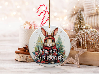 Bunny Christmas ceramic ornament featuring a rabbit in a red knit hat and scarf surrounded by festive Christmas trees.