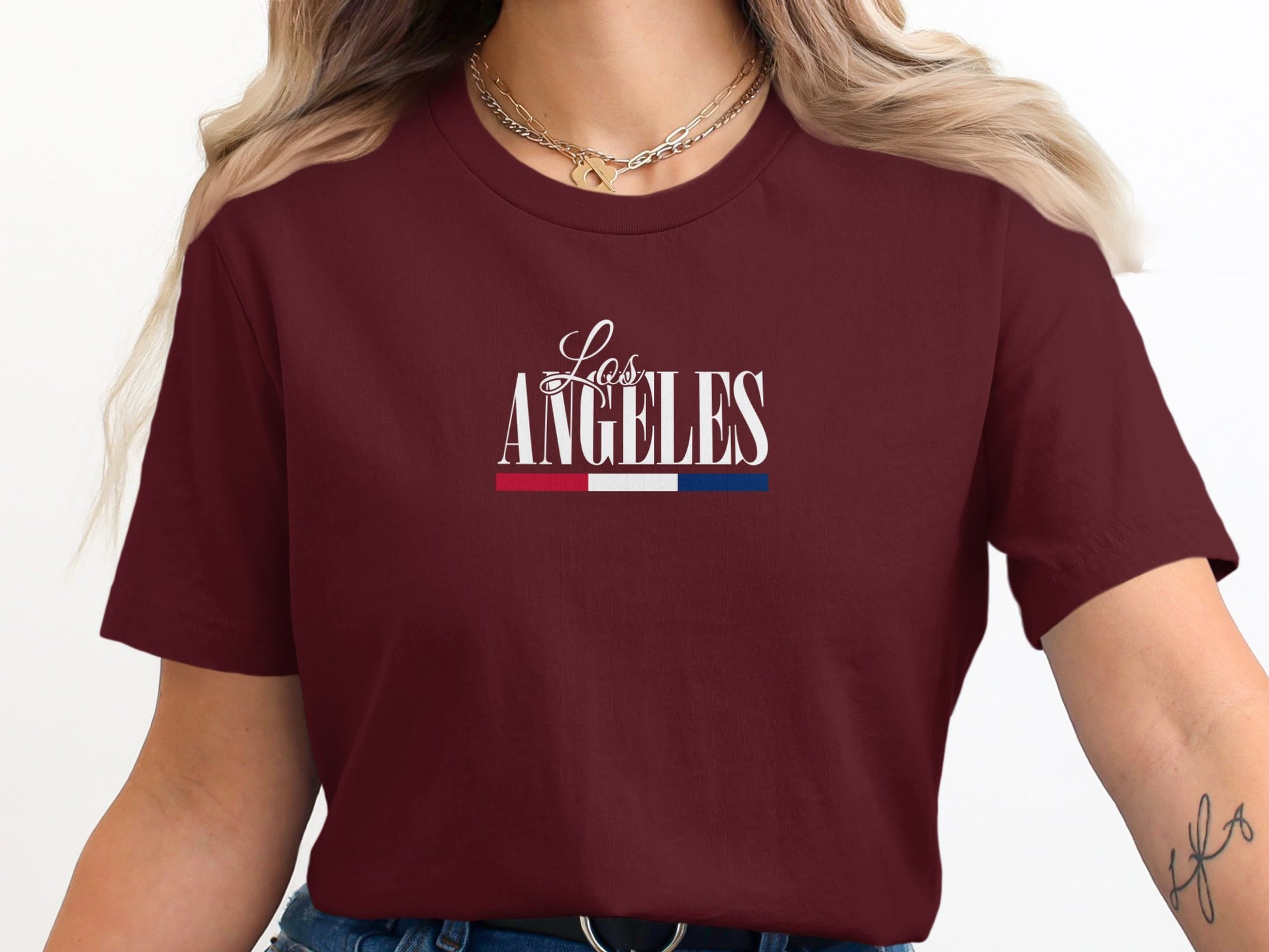 Maroon California Pride LA T-Shirt featuring modern LA script typography in clean centred chest layout with understated colour accent.