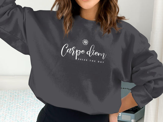 Carpe Diem Sweatshirt with small spiral sun chest graphic, flowing white script Carpe diem and spaced Seize The Day typography.