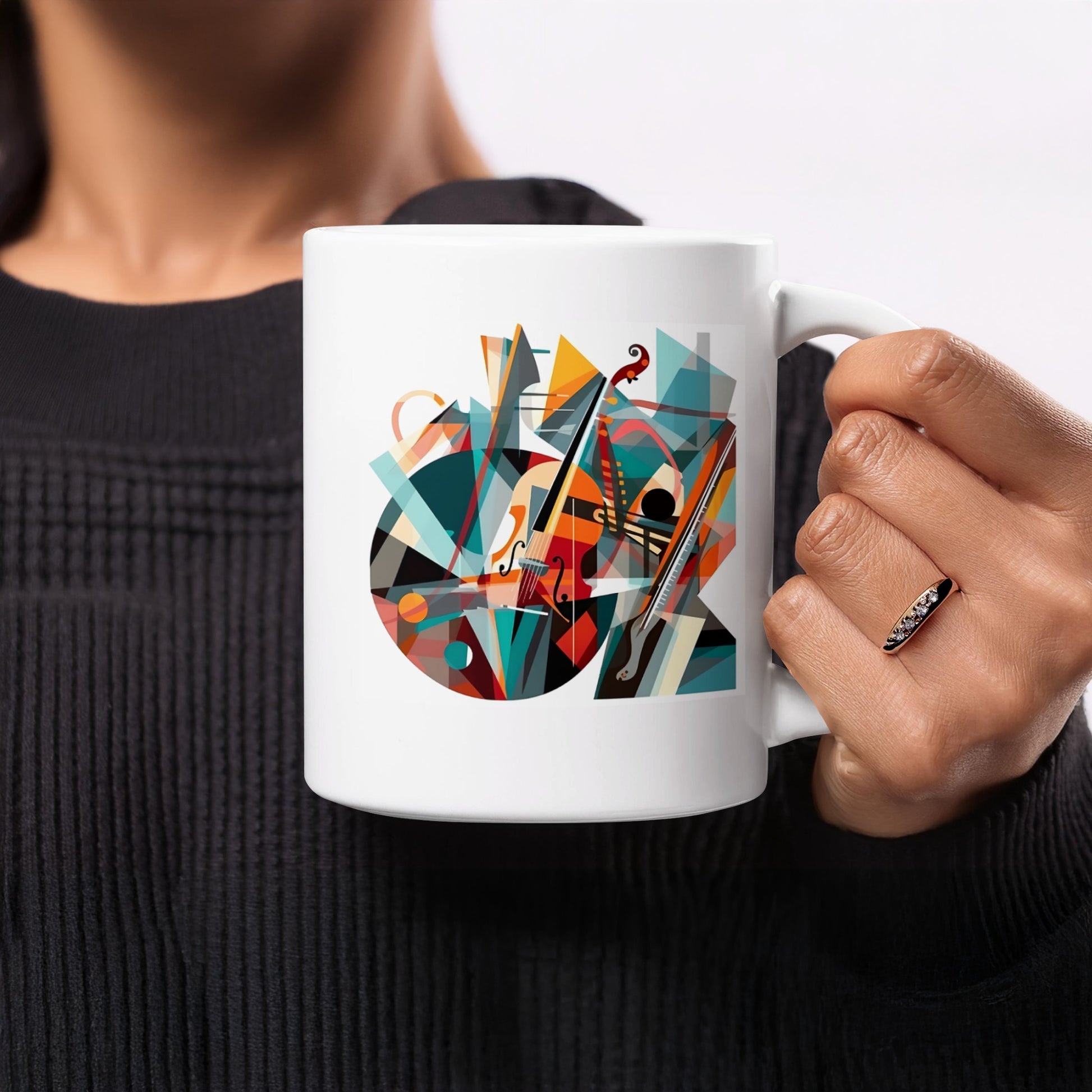 White coffee mug with cubist musical artwork featuring violin, woodwind instrument and flowing staff line details.