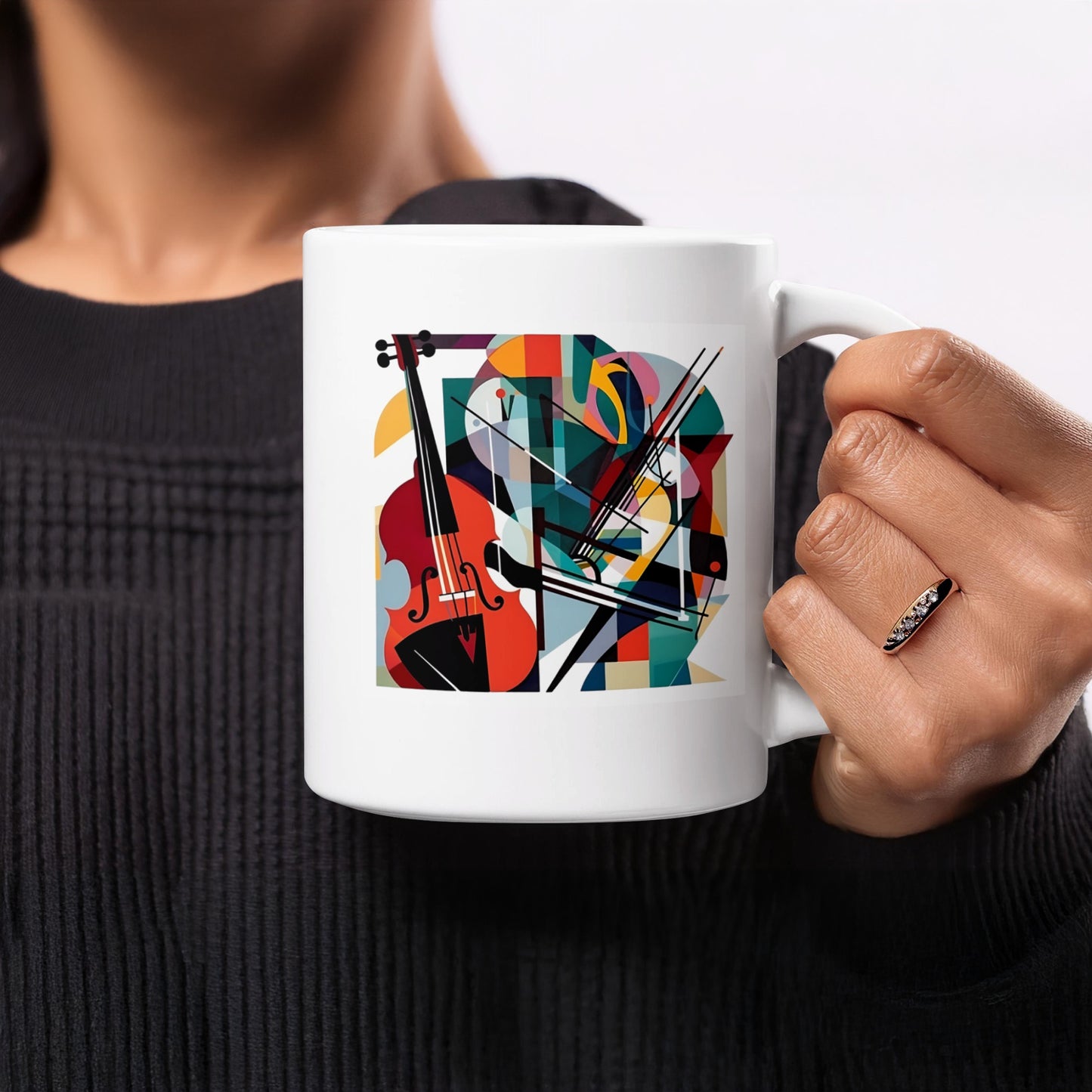 White coffee mug with abstract cello artwork featuring detailed f-holes, bows and overlapping colourful geometric forms.