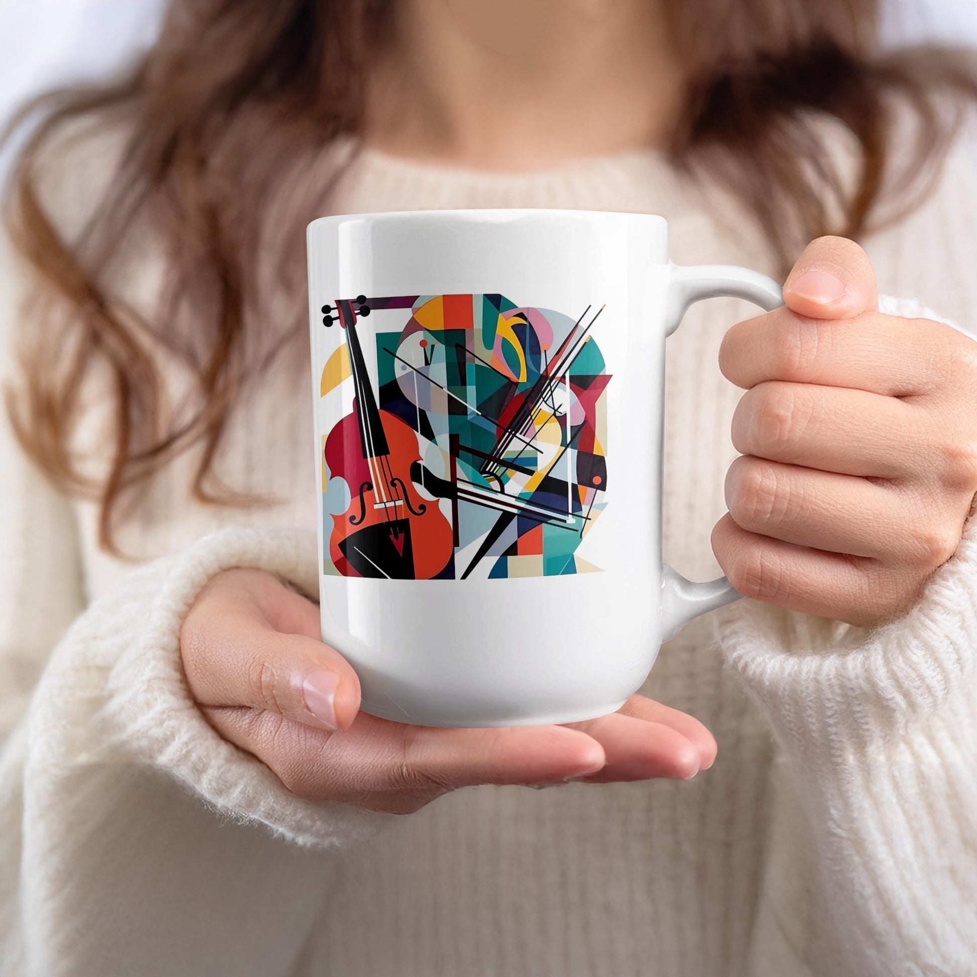 White 15oz mug held in hand featuring expressive cello artwork with bold geometric styling and vibrant colour contrasts.