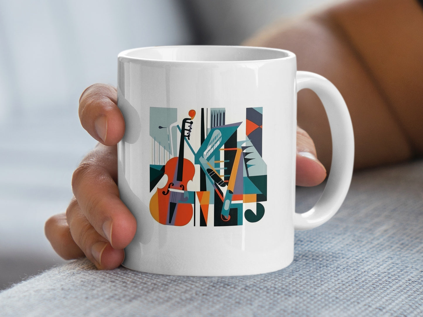 Handheld view showing contemporary music mug artwork with elegant cello illustration and refined geometric design.