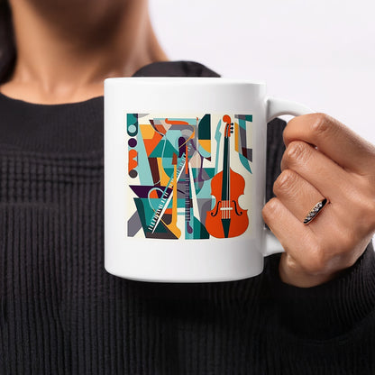White coffee mug with musical collage featuring cello, flute and brass details surrounded by colourful geometric forms.