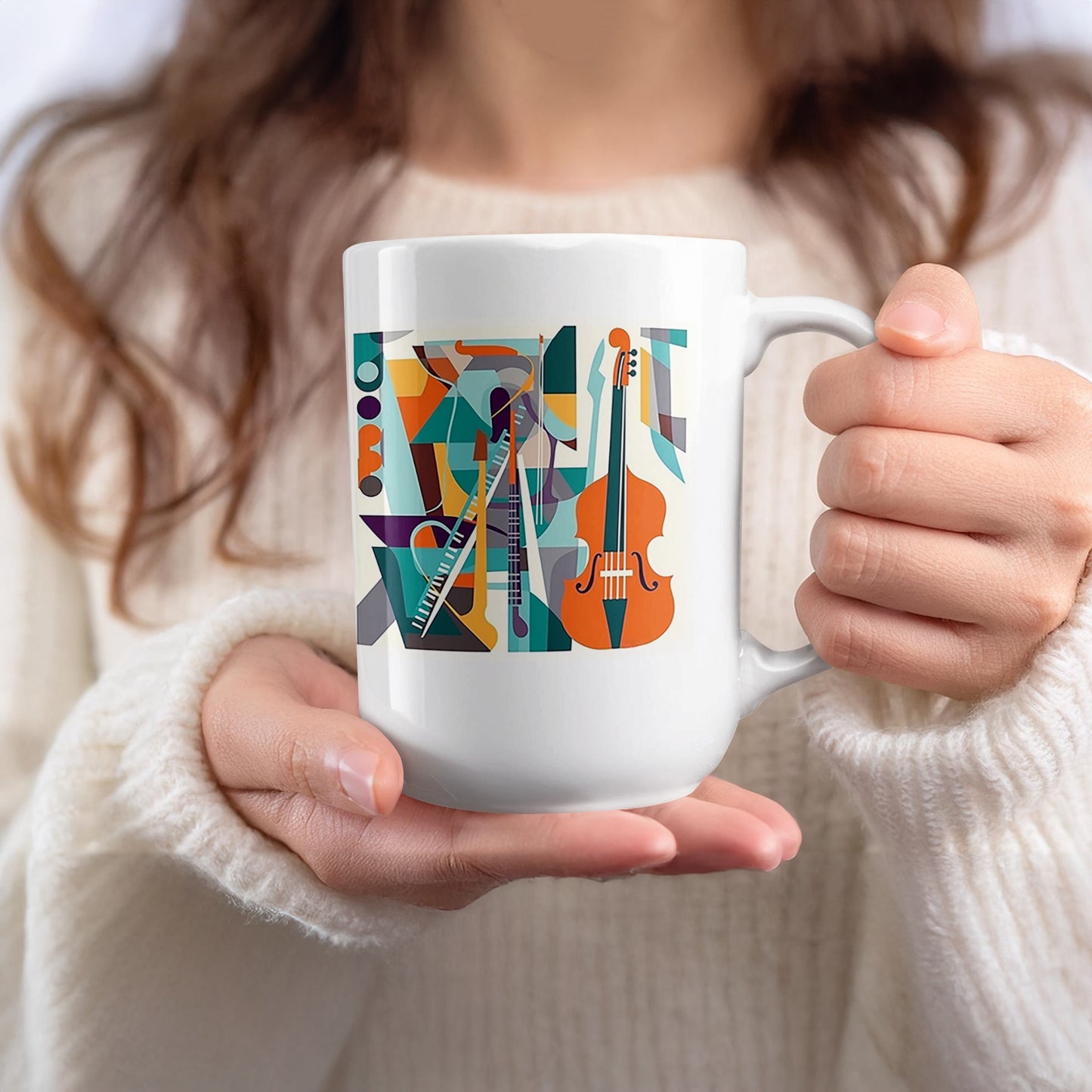 White 15oz mug held in hand featuring orchestral collage artwork with cello, instruments and vibrant geometric styling.