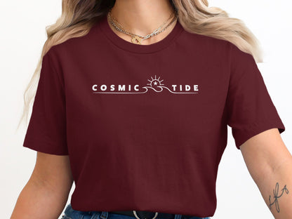 Maroon Cosmic Tide T-Shirt with centred cosmic typography and subtle integrated sun-wave-star illustration in clean modern layout.