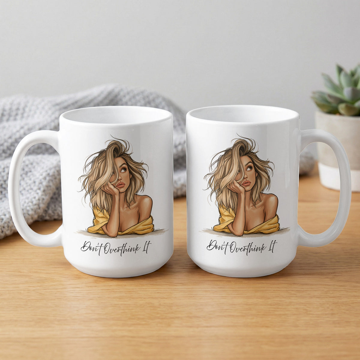 Two 15oz Don't Overthink It Mugs showing both sides with the blonde portrait, flowing black script and expressive linework.