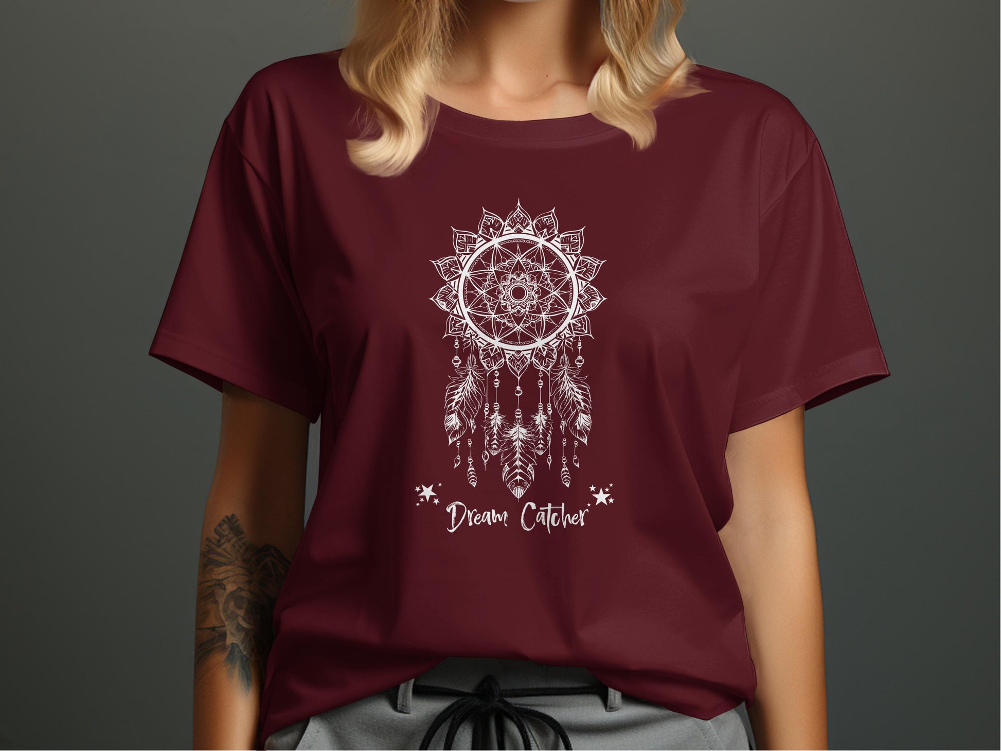 Maroon Dream Catcher T-Shirt with centred celestial-themed line art highlighting five detailed hanging feathers.