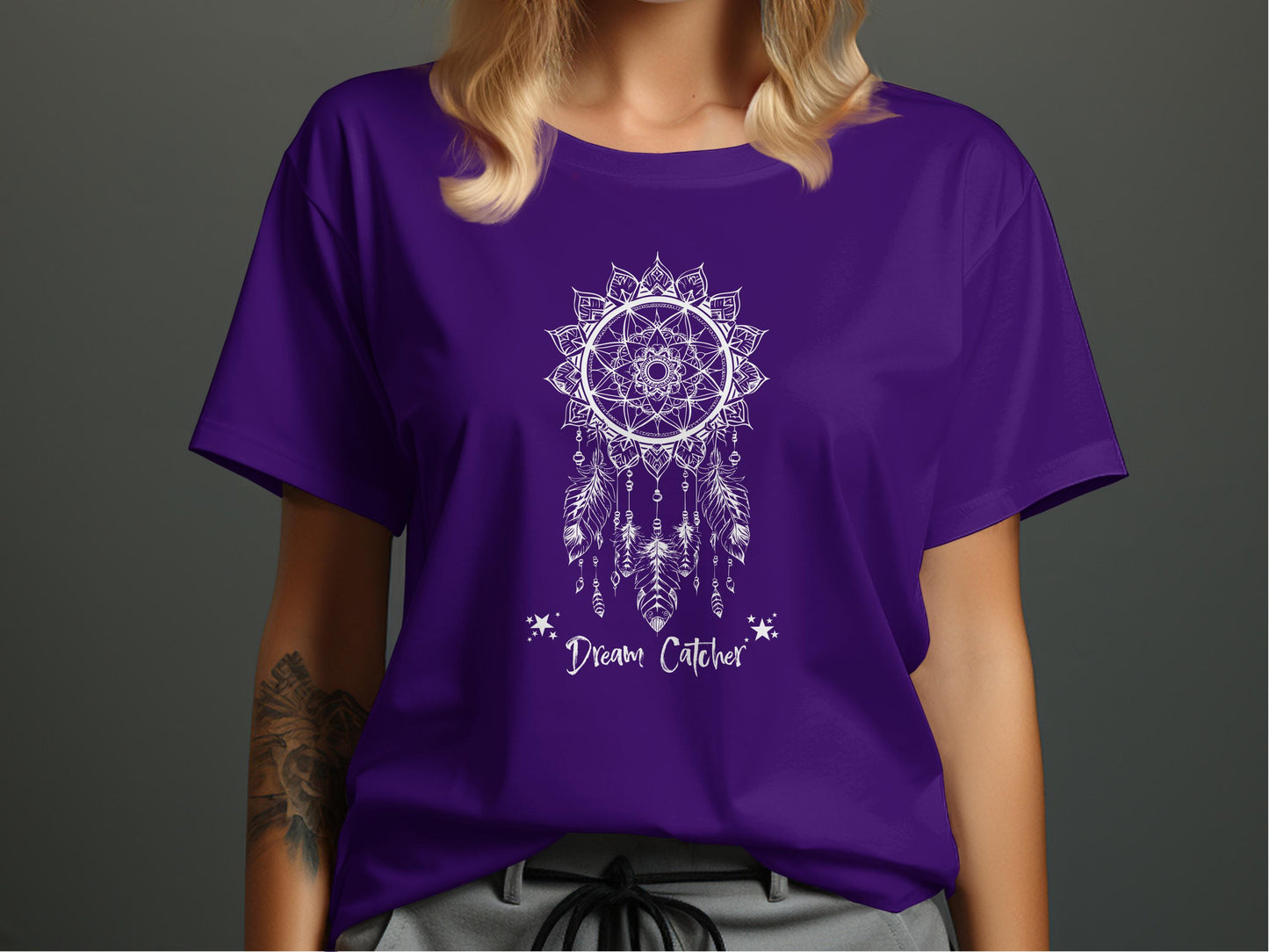 Purple Dream Catcher T-Shirt displaying a mystical bohemian design with flowing white cursive Dream Catcher lettering.