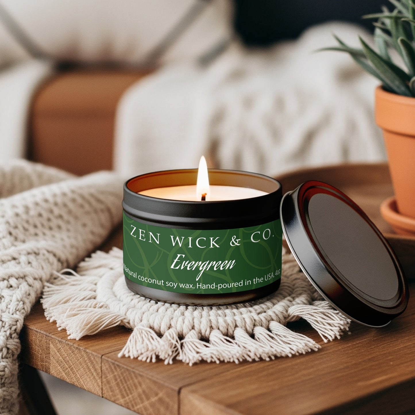Evergreen scented tin candle 4oz styled on coffee table adding a fresh natural aroma to everyday home spaces.