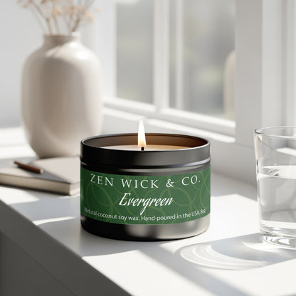 Evergreen scented tin candle 8oz burning beside window with natural light creating a refreshing forest-like ambiance.