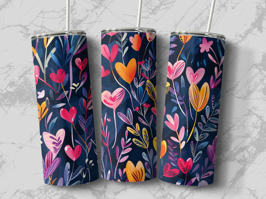 Skinny tumbler with crimson, blush, and golden heart flowers growing among illustrated garden leaves.