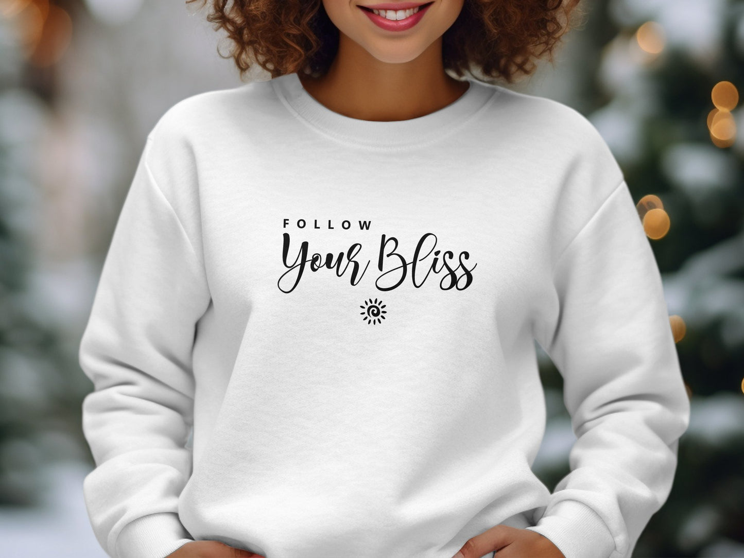 Follow Your Bliss sweatshirt featuring two-line quote typography with spiral sun icon, clean centre-chest print composition.