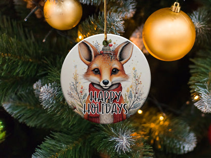 Ceramic Christmas ornament with charming fox artwork, red knitted scarf, and seasonal woodland details.