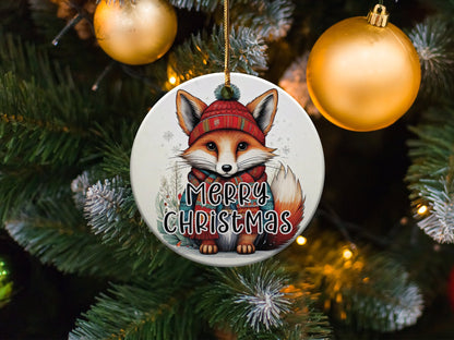 Ceramic Christmas ornament with watercolour fox artwork, festive winter accessories, and seasonal greenery.