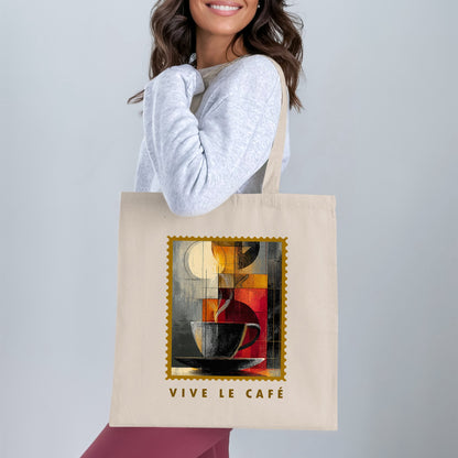 Fragmented Coffee Tote Bag with cubist coffee cup, pale cream disc and gold serrated border worn over shoulder.