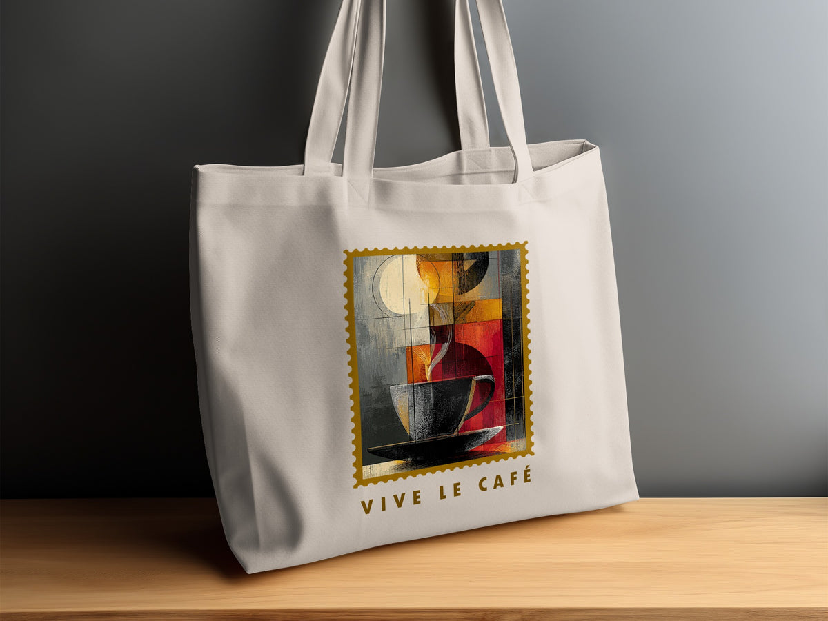 Fragmented Coffee Tote Bag on timber sideboard with charcoal cup, warm geometric artwork and VIVE LE CAFE subtitle.