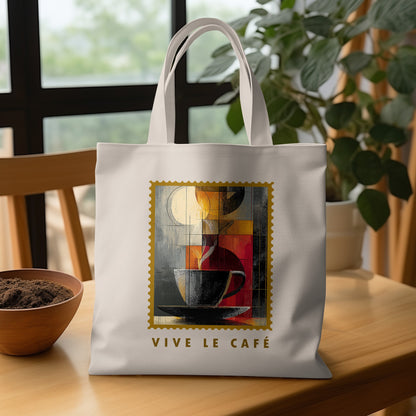 Fragmented Coffee Tote Bag with charcoal cup, pale cream disc, warm geometric panels and VIVE LE CAFE lettering on wooden table.
