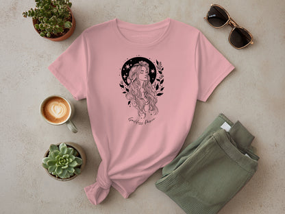 Flat lay of Goddess Power T-shirt in soft pink, unisex fit, short sleeve, trendy empowering boho style for casual wear.