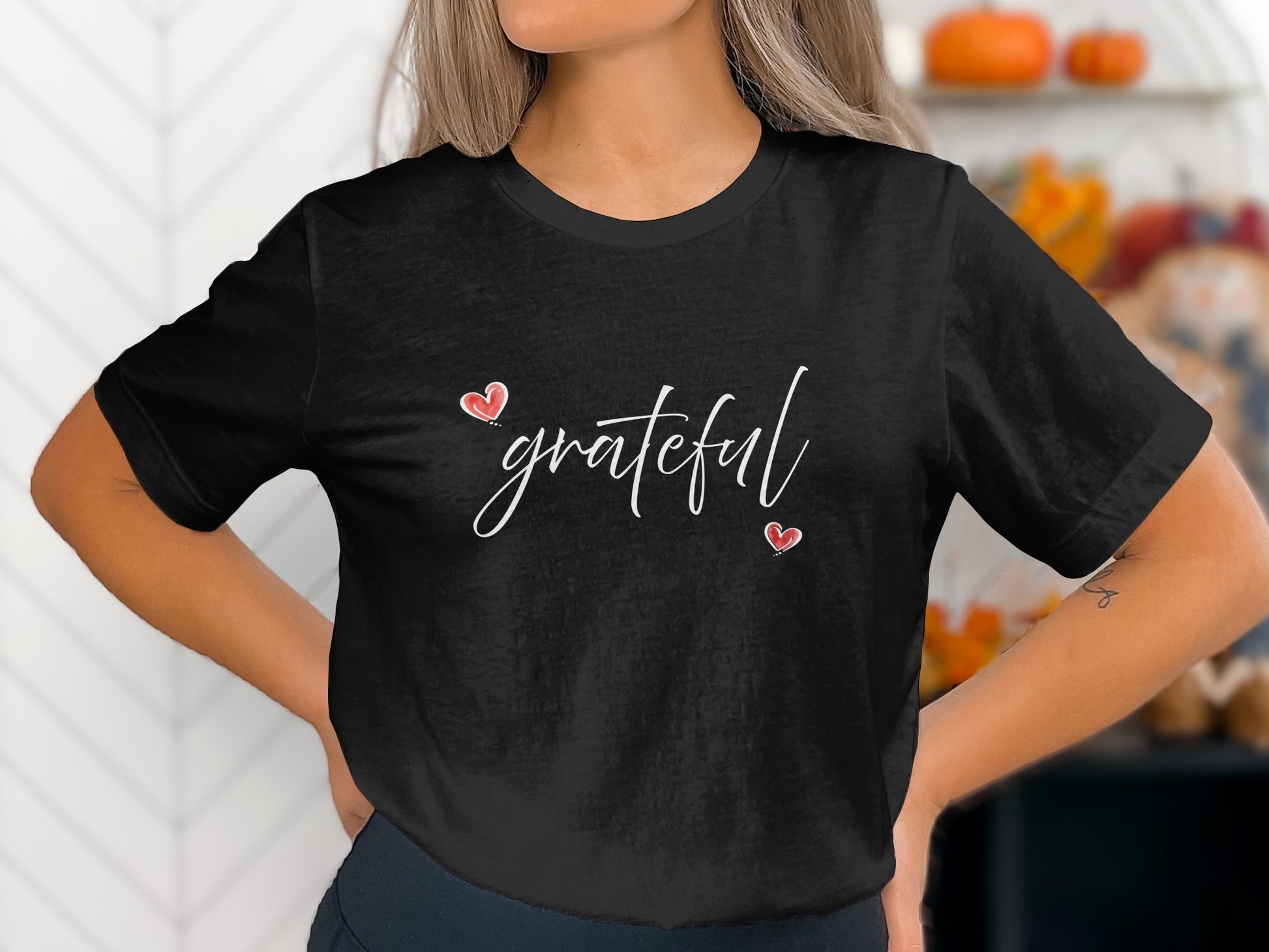 Black Grateful Heart T-Shirt with white handwritten script and two red heart accents arranged diagonally across the centre chest.