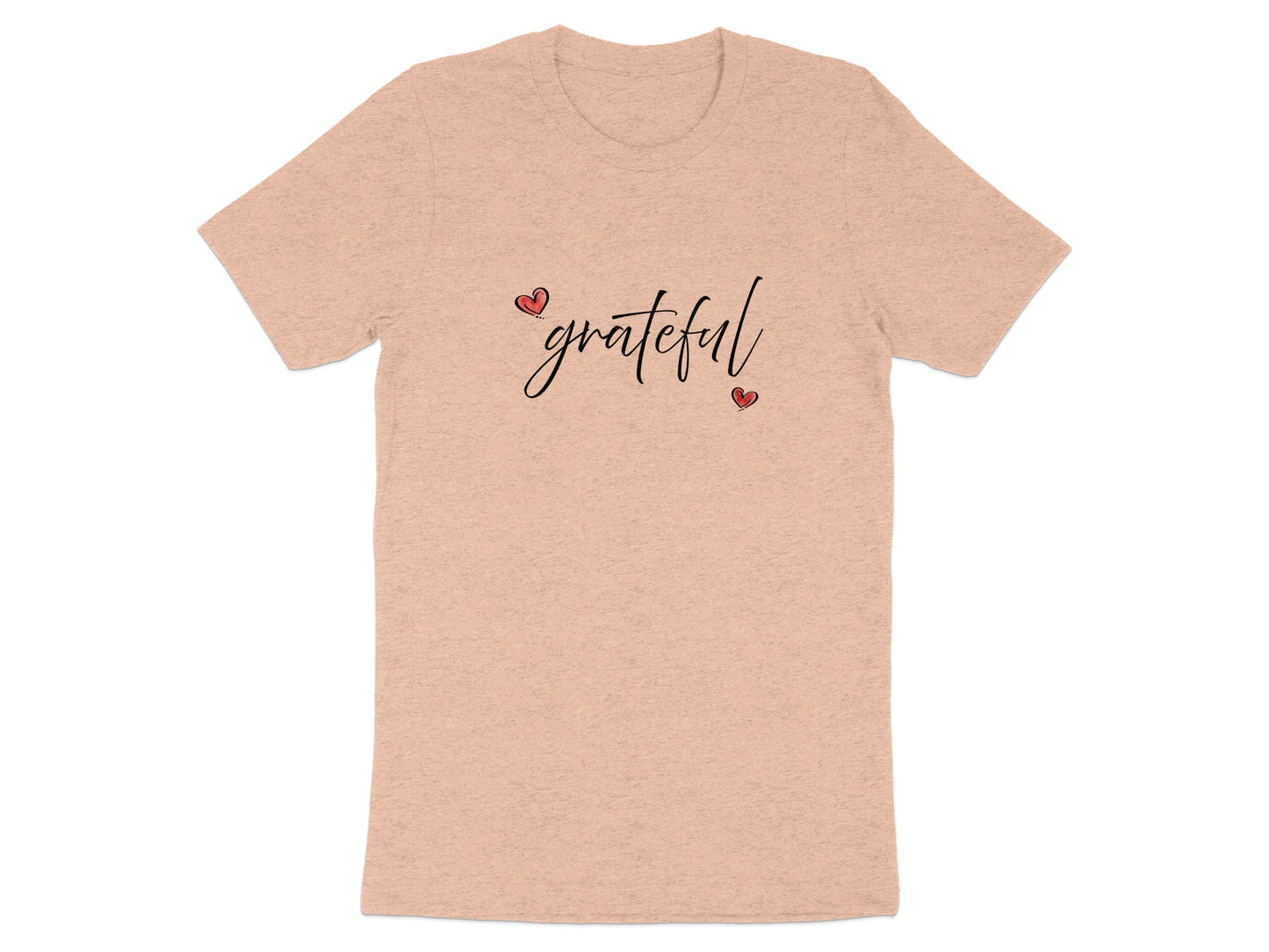 Heather peach Grateful Heart T-Shirt featuring handwritten-style black script and red heart details in a diagonal composition.