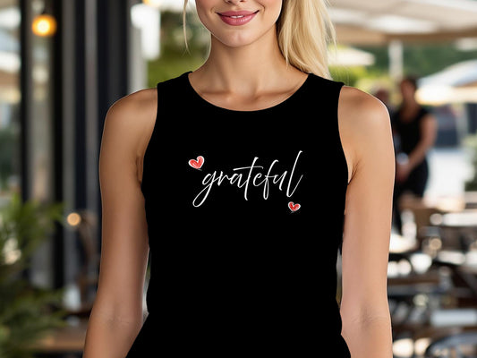 Black Grateful Heart graphic tank top with flowing white cursive lettering and two small red heart accents across the chest.