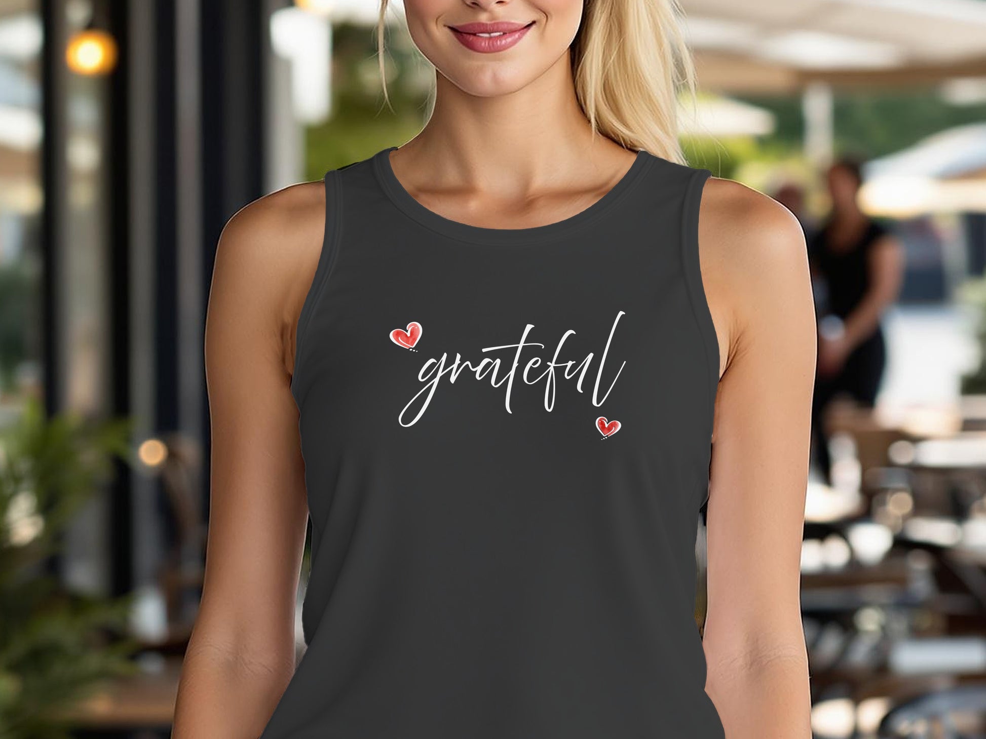 Charcoal Black Triblend Grateful Heart tank top with white cursive lettering framed by two red hearts diagonally positioned.