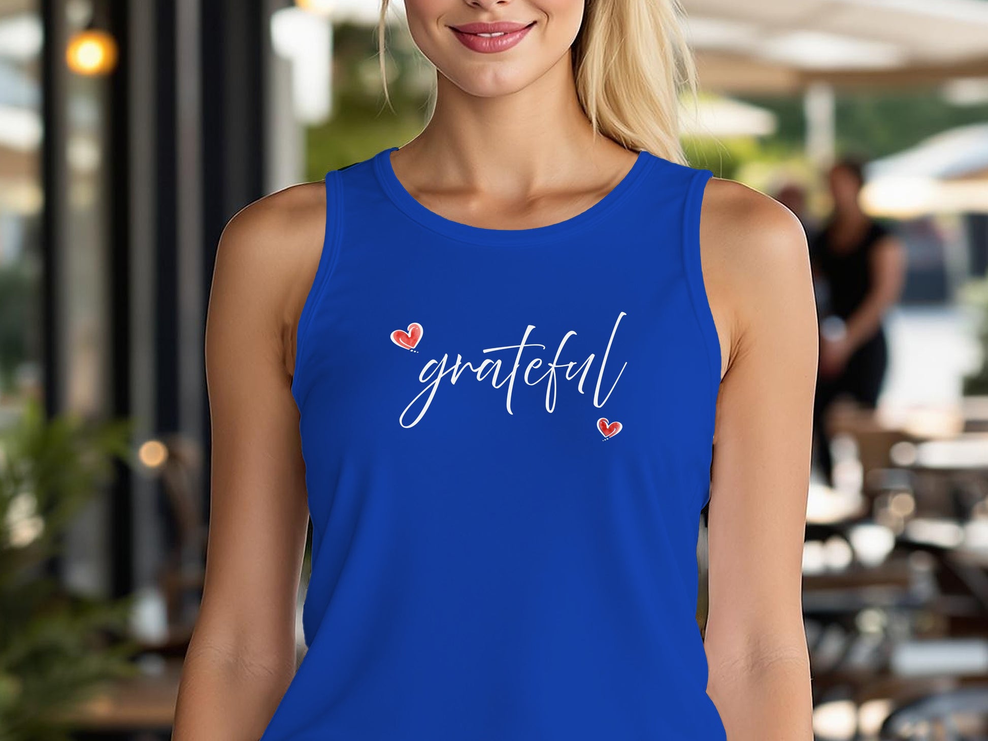 True Royal Grateful Heart tank top with minimalist 'grateful' white cursive script and two diagonal red heart accents.