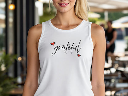 White tank top featuring Grateful Heart chest graphic with flowing handwritten black script and two small red heart accents.