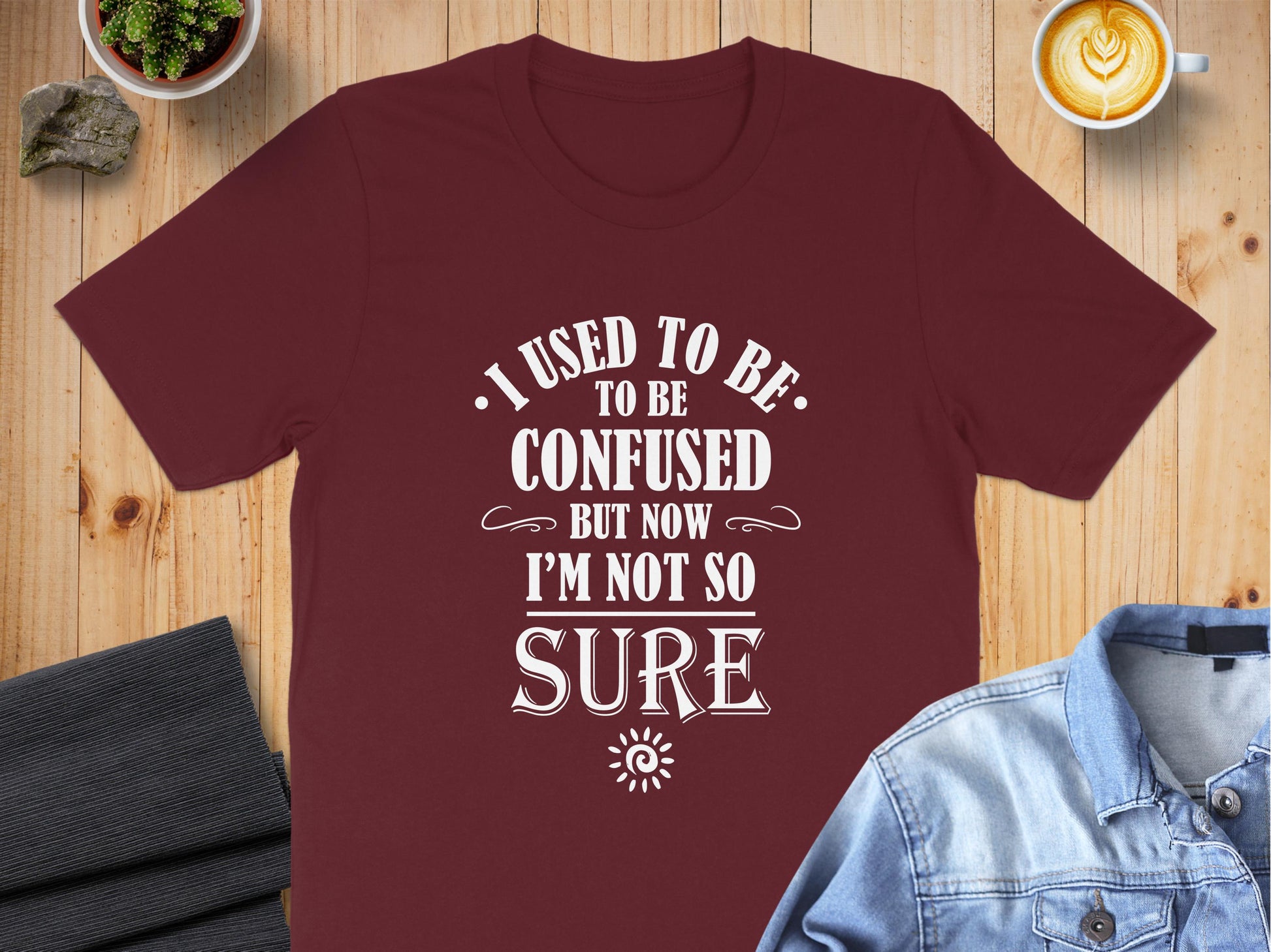 I Used To Be Confused T-Shirt in maroon featuring vintage-inspired quote typography, decorative flourishes, and oversized focal lettering.