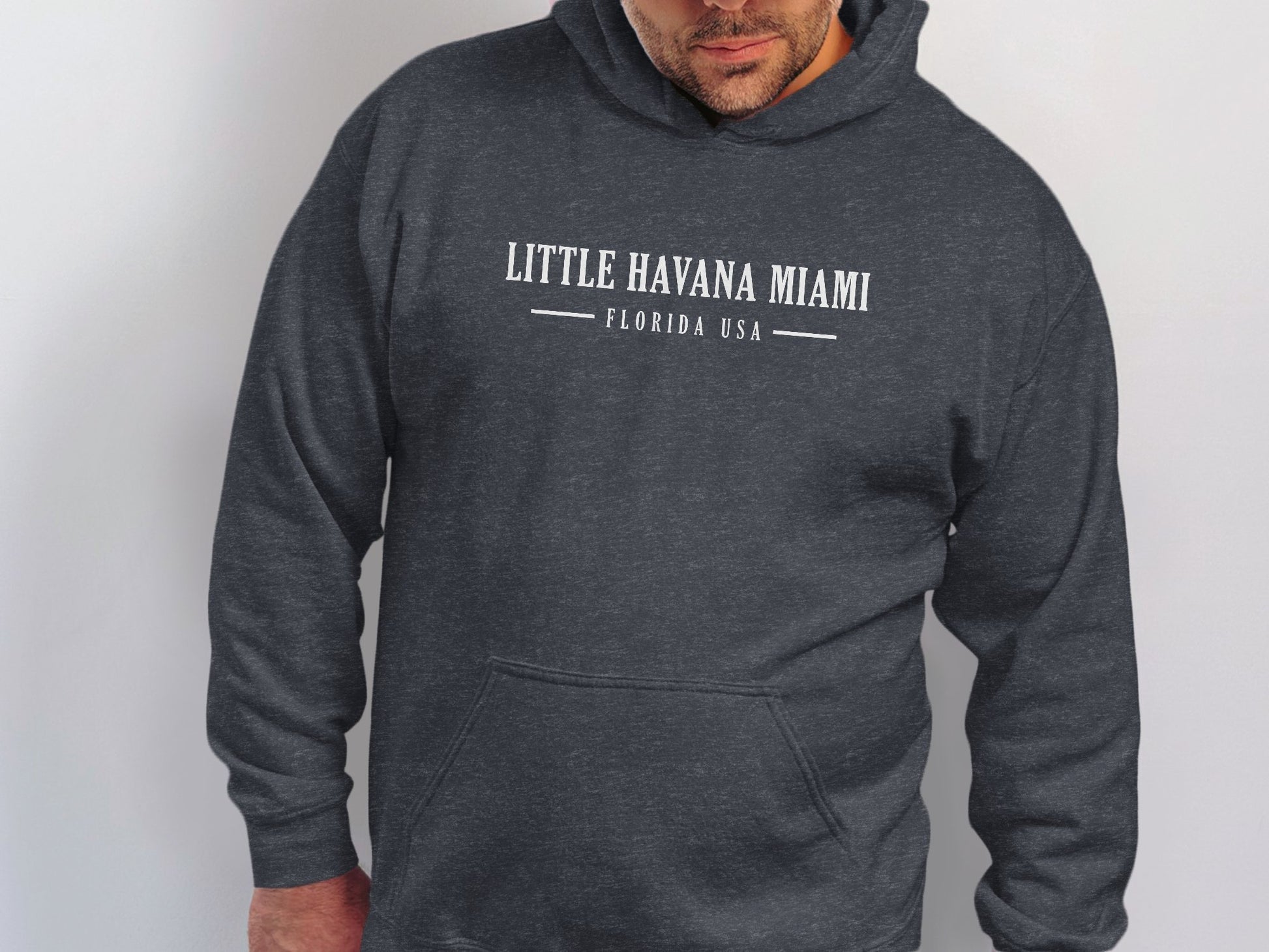 Dark heather grey Little Havana Miami Hoodie with white distressed serif typography and vintage Miami destination centre-chest.