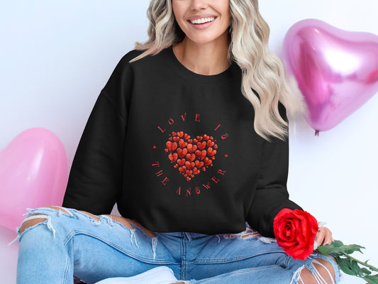 Black Love Is the Answer sweatshirt with red inspirational message, crew neck, unisex fit, and cozy cotton-poly blend.
