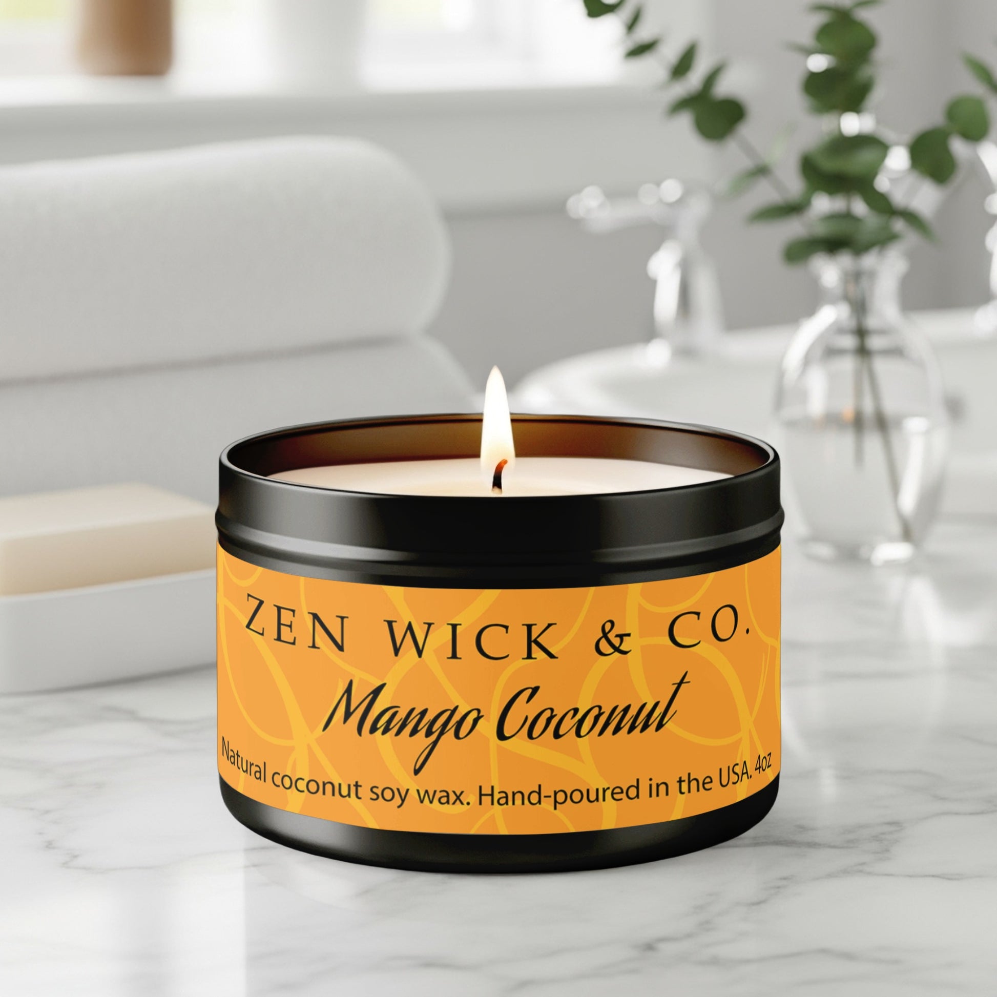 Mango coconut scented candle 4oz burning on table with soft glow creating a bright tropical ambiance.