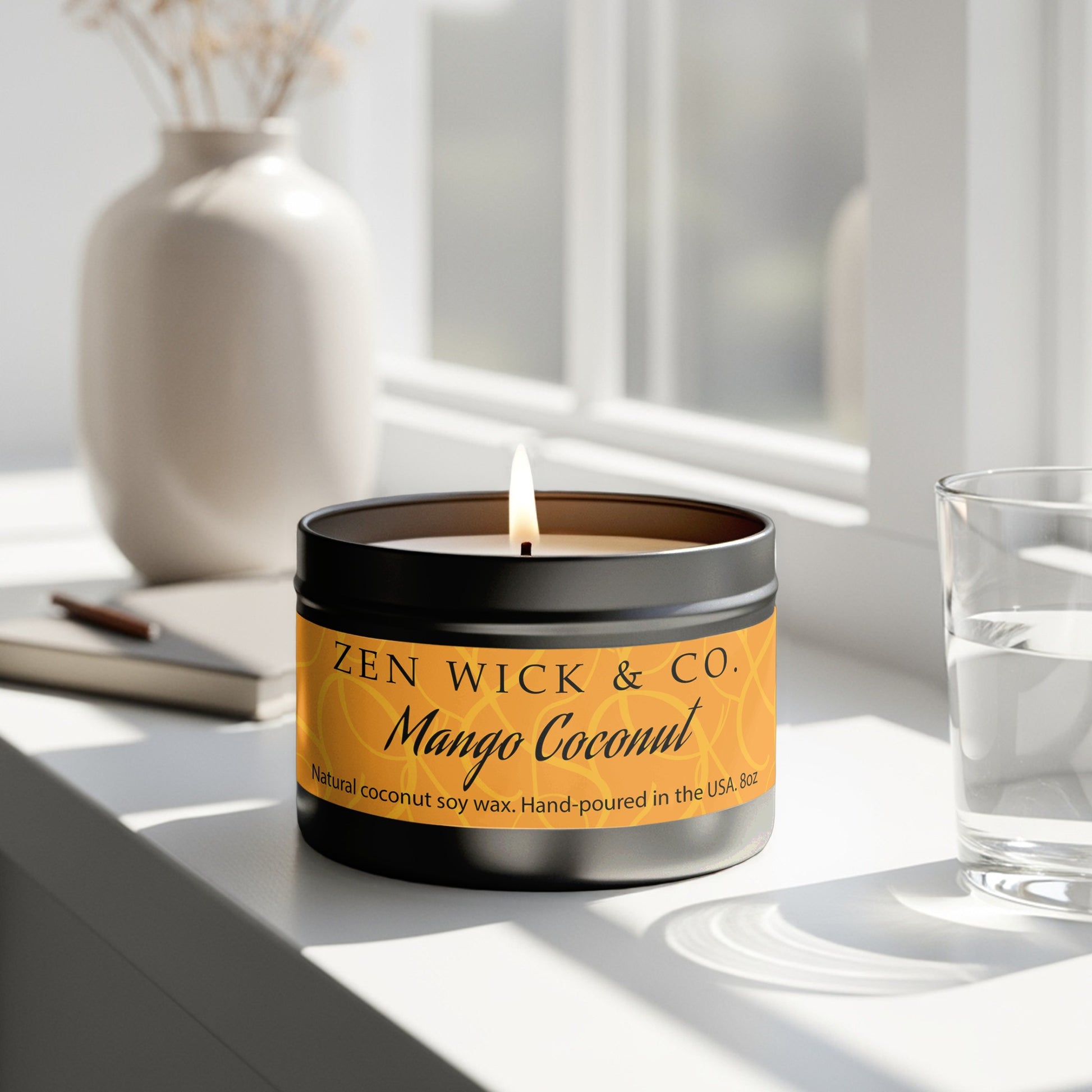 Mango coconut scented candle 8oz burning beside window with natural light creating a warm tropical mood.