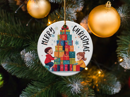 Ceramic holiday ornament showcasing a festive gift-opening scene with children and Merry Christmas text.