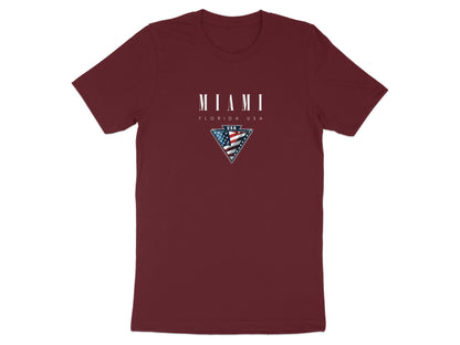 Maroon Miami T-shirt featuring white serif Miami typography and framed Americana-style flag emblem.