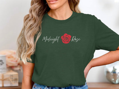 Forest Green Midnight Rose T-Shirt showcasing white flowing script and a single red rose against a clean background.