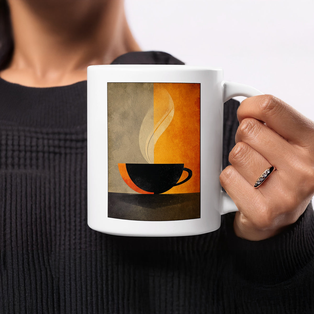 Handheld 11oz white Minimalist Coffee and Steam Mug showing a bold black silhouette against contrasting warm and cool tones.