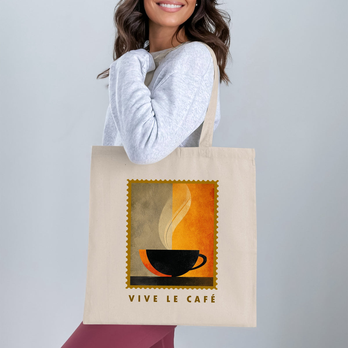 Minimalist Coffee & Steam Tote Bag with black cup silhouette and cream steam curl worn over shoulder.