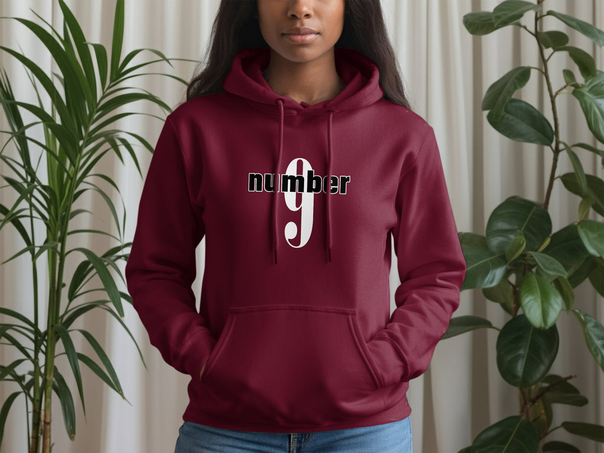 Maroon Number 9 Hoodie showcasing bold numeric 9 design with clean centred black wordmark and collegiate-inspired symmetry.