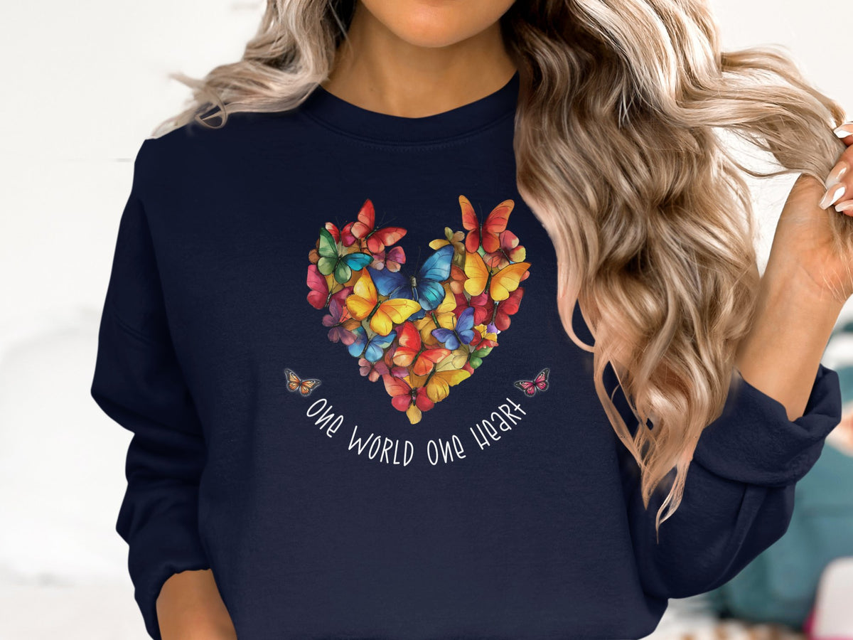 Navy One World One Heart sweatshirt featuring layered butterfly heart artwork and curved white handwritten quote typography.