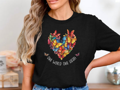Black One World One Heart T-shirt featuring multicolour butterfly heart composition with handwritten script beneath, centred chest print.