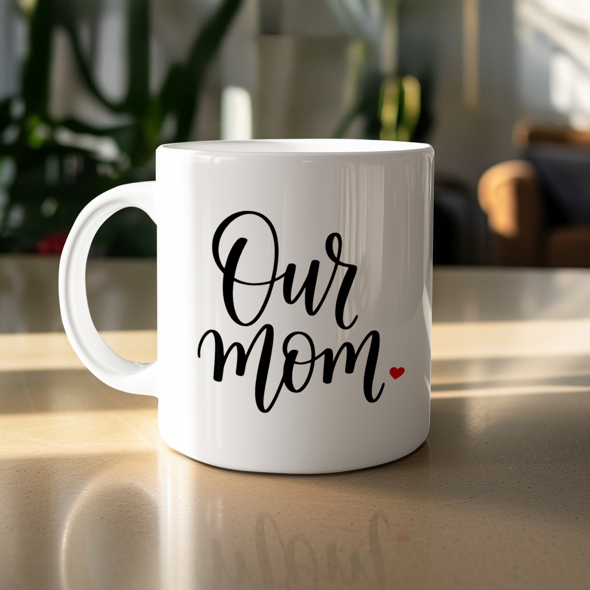 Our Mum Heart 11oz ceramic mug on table with scripted text and red heart, perfect for daily coffee and family gifting.