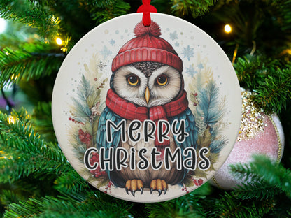 Woodland owl ornament featuring golden-eyed owl, red beanie, cosy scarf, and snowy forest accents.