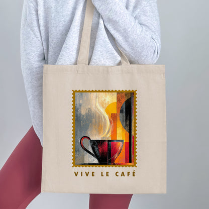 Painterly Steam Tote Bag held by a woman, with charcoal-red cup, sweeping cream steam, gold border and VIVE LE CAFE lettering.