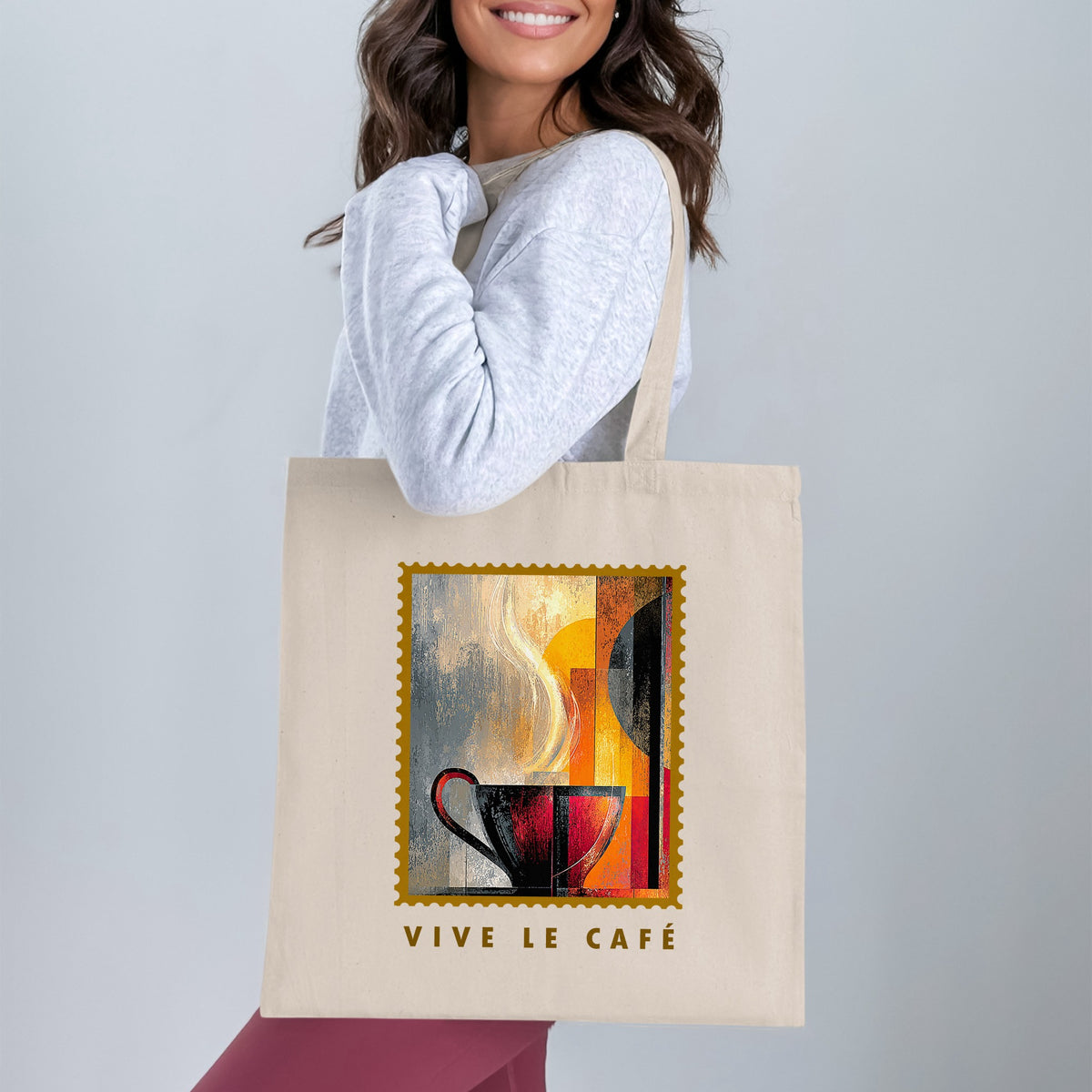 Painterly Steam Tote Bag with charcoal-red coffee cup, sweeping cream steam and gold serrated border worn over shoulder.